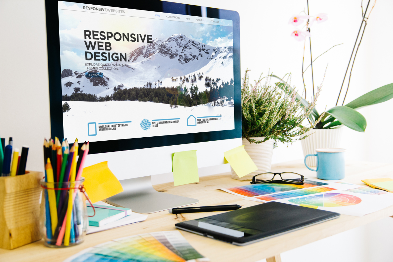 Dual monitors displaying website design and development work on a desk, representing the process of creating custom WordPress websites.